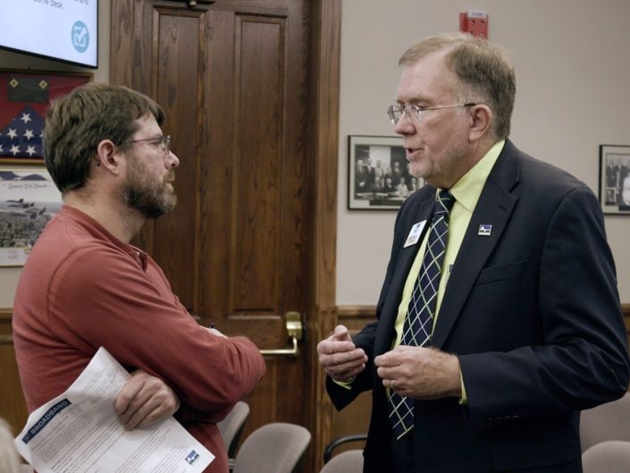 Steve Talking at Town Hall Presentation Steve Talking With Man In Red