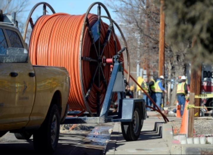 Orange conduit being pulled by a truck
