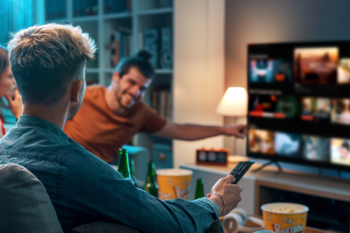 Image of friends gathered around a TV.
