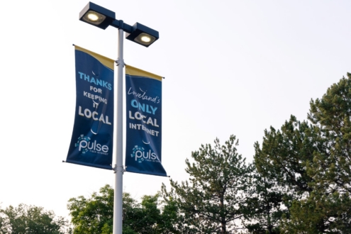 Light post banners for Pulse Fiber that say thanks for keeping it local and Loveland's only local internet