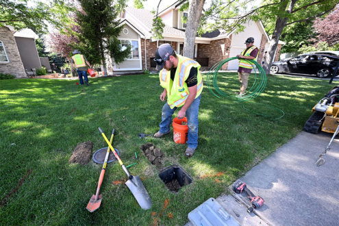An underground construction crew with Pulse works to install fibers and coduit for internet Friday at a home in northwest Loveland. From left are Joshua Bernatski, Anthony Miguel and Zach Trolliet.